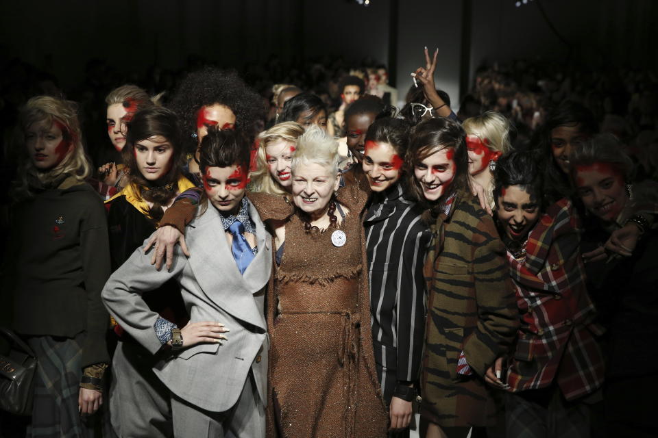 FILE - British designer Vivienne Westwood poses with models after her Autumn/Winter 2015 show at London Fashion Week in London, Feb. 22, 2015. Westwood, an influential fashion maverick who played a key role in the punk movement, died Thursday, Dec. 29, 2022, at 81. (AP Photo/Alastair Grant, File)