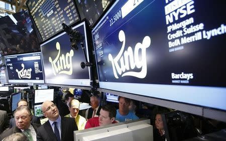 King CEO Riccardo Zacconi (2nd L) looks on as traders work during the IPO of Mobile game maker King Digital Entertainment Plc on the floor of the New York Stock Exchange March 26, 2014. REUTERS/Brendan McDermid