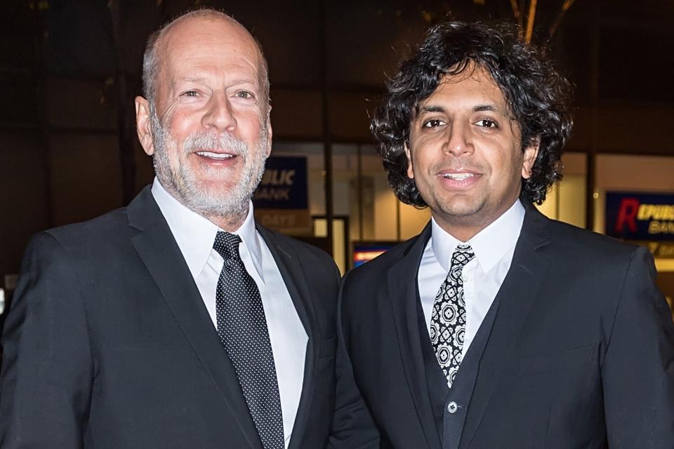 Recipient of the 2nd annual Lumiere award actor Bruce Willis and Film director M. Night Shyamalan arrive in a 2017 Tesla Model S 100D Sedan at the 2nd Annual Lumiere Award Celebration during The 26th Philadelphia Film Festival at AKA Washington Square on October 26, 2017 in Philadelphia, Pennsylvania.