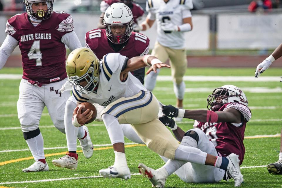 Salesianum's B.J. Alleyne (2) tries to break away from Hodgson's Nybree Davis (0) on Saturday at St. Georges. The Sals beat the Silver Eagles 38-19.