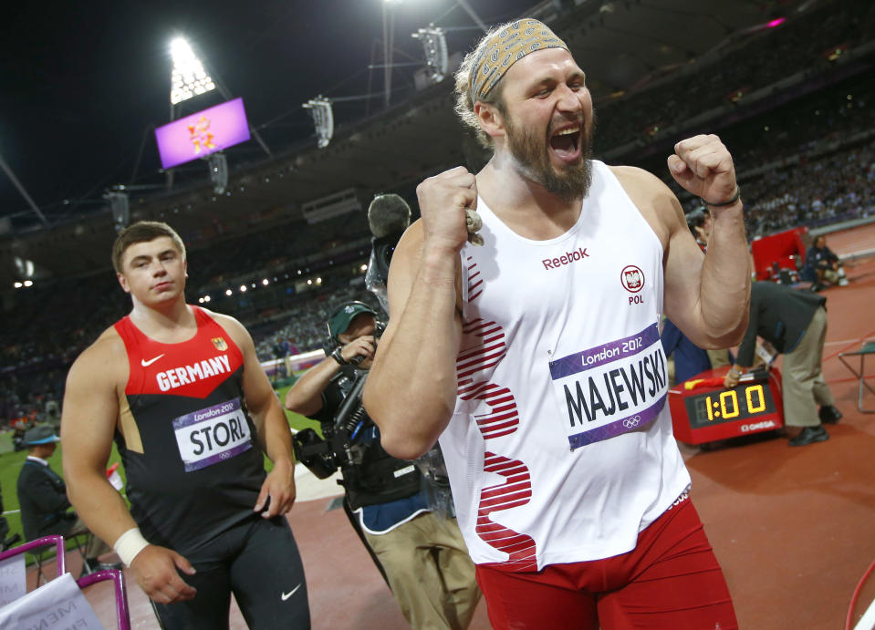 Germany's David Storl watches as Poland's Tomasz Majewski celebrates after winning men's shot put final at London 2012 Olympic Games