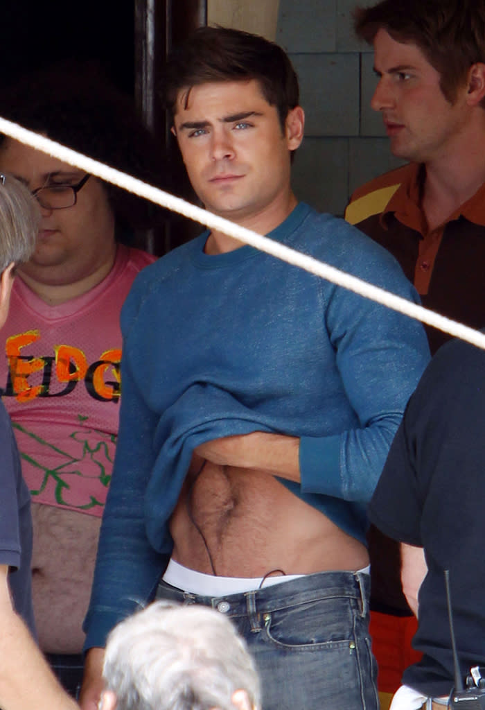 <b>Who:</b> Zac Efron<br><br> <b>Wearing:</b> Blue sweatshirt, jeans, tighty whities, fab abs<br><br> <b>Where:</b> On the set of "Townies" in Los Angeles