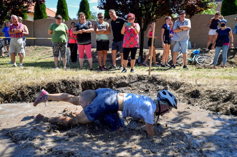 Participants compete in a wife-carrying championship
