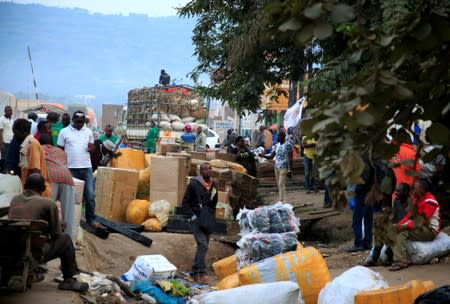 FILE PHOTO: Ugandan business people are seen at a market with their merchandises for sale at Mpondwe border that separates Uganda and the Democratic Republic of Congo in Mpondwe