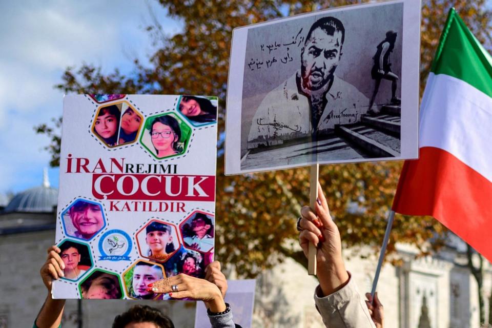 PHOTO: People hold placards bearing portraits of Iranian rapper Toomaj Salehi , who is arrested in Iran, and portraits of children, who were killed during the protests in Iran, during a rally in support of Iranian women in Istanbul, on November 26, 2022. (Yasin Akgul/AFP via Getty Images)