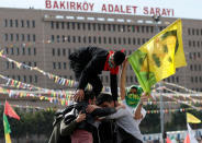 A man holds a flag with a picture of imprisoned Kurdish rebel leader Abdullah Ocalan during a gathering to celebrate Newroz, which marks the arrival of spring and the new year, in Istanbul, Turkey March 21, 2018. REUTERS/Murad Sezer