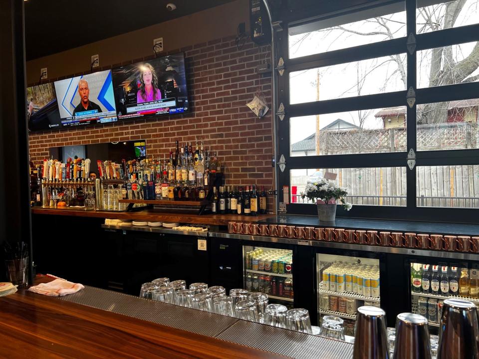 The bar at Bix & Co. features a foot rail made from a trolley track that once ran along Ingersoll Avenue and railroad spikes.