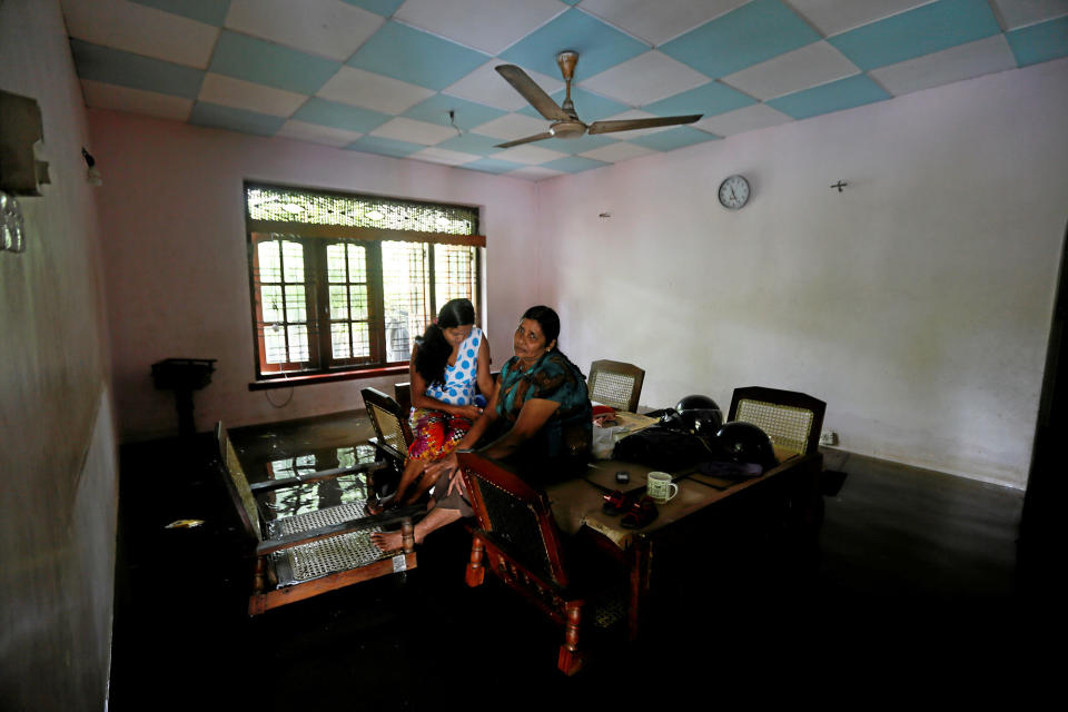 <p>A family sits on a table inside their flooded house in Nagoda village in Kalutara, Sri Lanka, May 29, 2017. (Dinuka Liyanawatte/Reuters) </p>