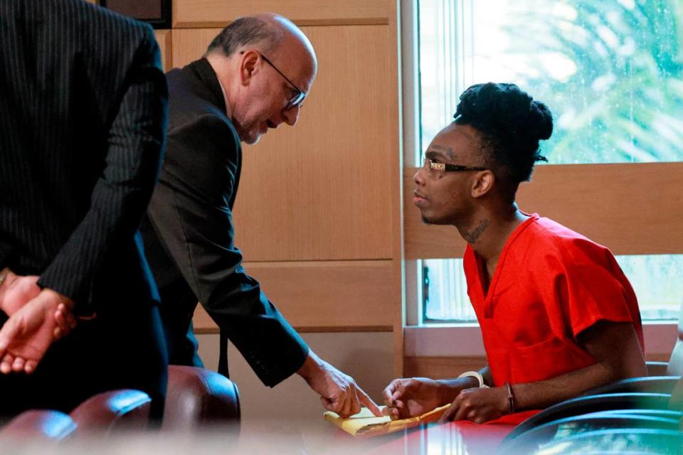 Jamell Demons, better known as rapper YNW Melly speaks with his attorney Stuart Adelstein during a bond hearing before Broward Circuit Judge John Murphy on Friday, September 15, 2023. His previous trial ended in a mistrial after the jury was deadlocked and unable to reach a verdict in July 2023. Demons, 24, is accused of killing two fellow rappers and conspiring to make it look like a drive-by shooting in October 2018. (Mike Stocker/South Florida Sun Sentinel)