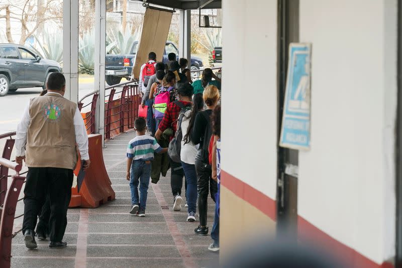 The first group of 25 migrants leave their camp towards the Gateway International Bridge