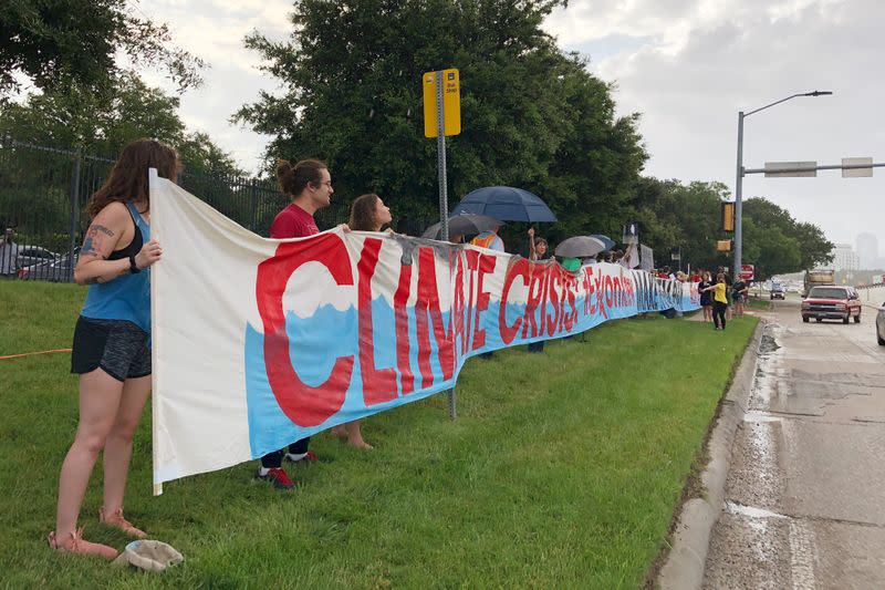 FILE PHOTO: Protestors gather outside the ExxonMobil annual shareholders meeting to protest the company’s climate policies as people arrive at the 2019 annual shareholders meeting in Dallas