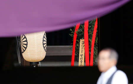 A wooden sign which reads "Prime Minister Shinzo Abe" is seen on a ritual offering, a "masakaki" tree, from Abe to the Yasukuni Shrine, inside the main shrine at the controversial shrine for war dead, in Tokyo, Japan April 21, 2017. REUTERS/Toru Hanai