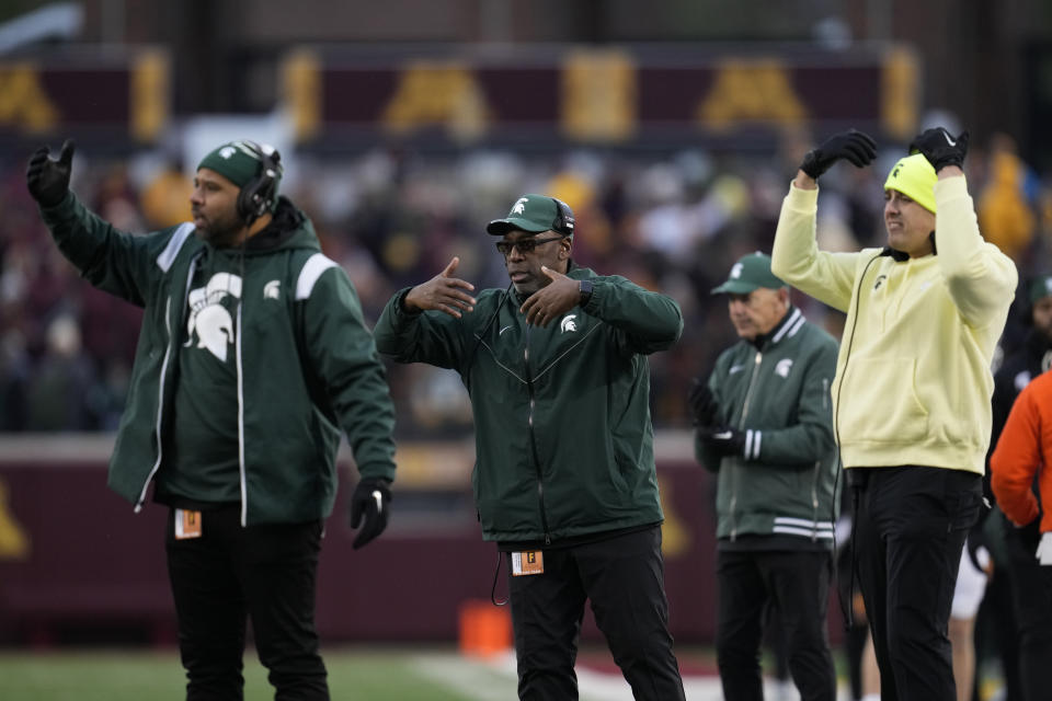 Michigan State interim head coach Harlon Barnett, center, signals to players during the second half of an NCAA college football game against Minnesota, Saturday, Oct. 28, 2023, in Minneapolis. (AP Photo/Abbie Parr)