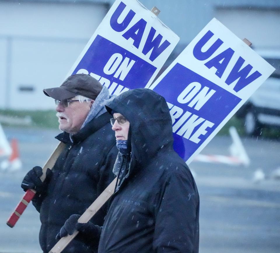 CNH Industrial workers Dan Eppers, left, and Mike Callahan, right, picket outside Thursday, Nov. 17, 2022, in Mount Pleasant, Wis. They have been on strike since May 2022.