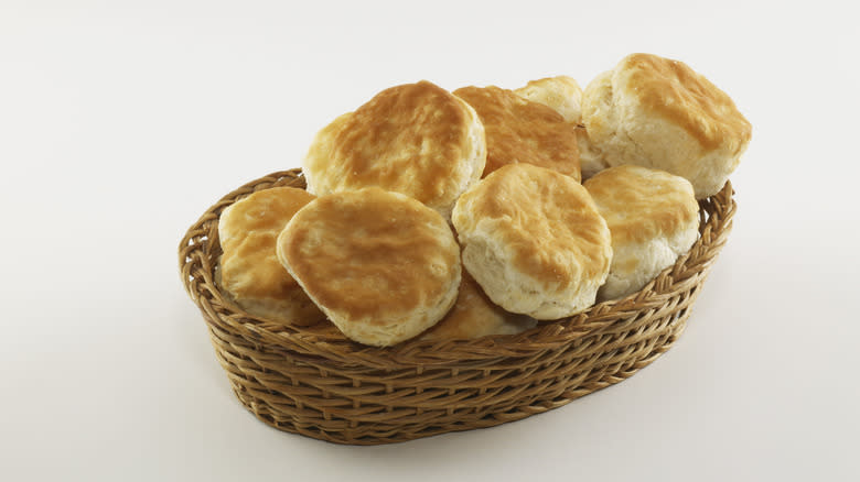 Biscuits in basket on white surface
