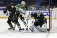 Tampa Bay Lightning goaltender Andrei Vasilevskiy, right, makes a save in front of Dallas Stars' Roope Hintz (24) as Ryan McDonagh defends during the first period of an NHL hockey game Saturday, Feb. 27, 2021, in Tampa, Fla. (AP Photo/Mike Carlson)