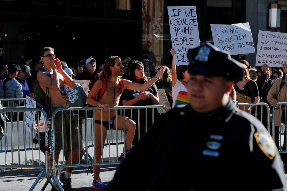 Demonstrators arrive to Trump Tower during a protest against U.S. President-elect Donald Trump in Manhattan, New York, U.S. November 19, 2016. REUTERS/Eduardo Munoz