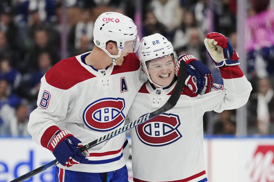 Montreal Canadiens' Cole Caufield (22) celebrates his goal against the Toronto Maple Leafs with Mike Matheson (8) during the third period of an NHL hockey game Wednesday, Oct. 11, 2023, in Toronto. (Frank Gunn/The Canadian Press via AP)