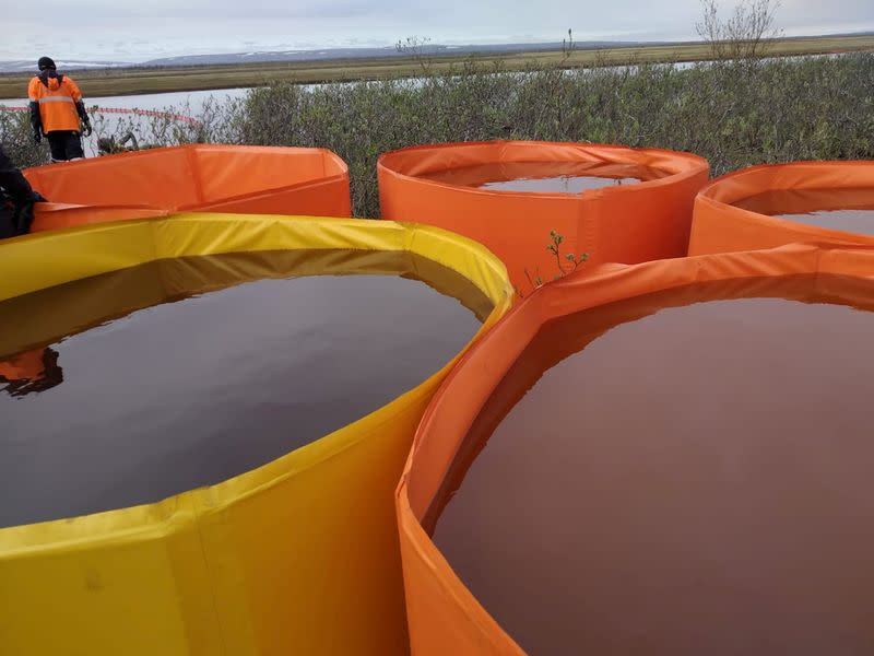 Rescuers work at the site of a huge leak of fuel into the river after an accident at a power plant outside Norilsk