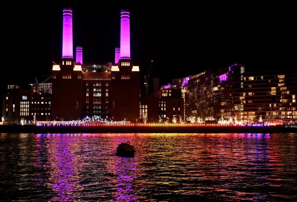 Chimneys on Battersea Power Station are illuminated purple (REUTERS)