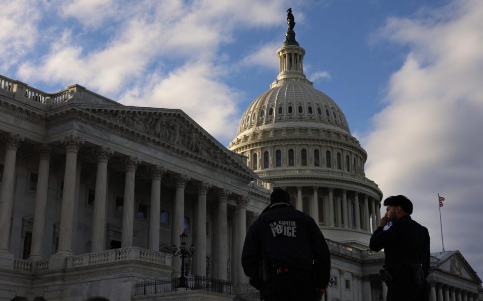 Capitol police officers patrol the East Front plaza of the US Capitol Building