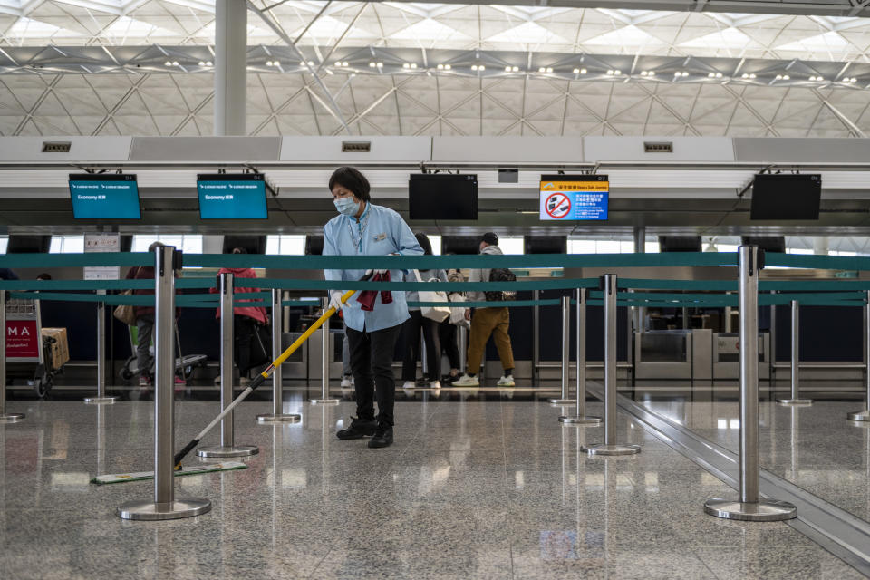 A Worker is seen mopping the floor inside the terminal of the Hong Kong International Airport on February 22, 2020 in Hong Kong, China. the coronavirus or Covid-19 which originated from Wuhan China has infected over 77,000 and killed 2361 worldwide to date, passenger flights into and out of the Hong Kong has drop by two-thirds with airlines cancelling flights and travellers plummet because of the Coronavirus in Hong Kong. (Photo by Vernon Yuen/NurPhoto via Getty Images)