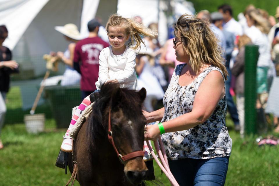 McKenna Kriner (age 4), with her mother, Hillary Kriner of Middletown, enjoys a pony ride at the 38th Annual Point to Point.