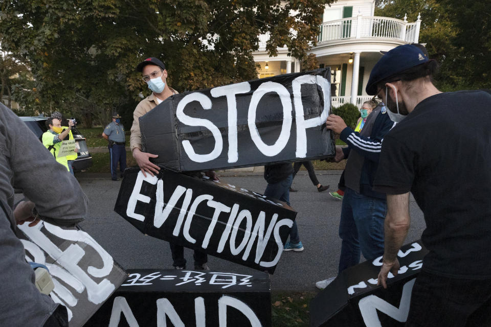 FILE - In this Oct. 14, 2020, file photo, housing activists erect a sign in front of Massachusetts Gov. Charlie Baker's house in Swampscott, Mass. The Justice Department said Saturday, Feb. 27, 2021 it will appeal a judge’s ruling that found the federal government’s eviction moratorium was unconstitutional. Prosecutors filed a notice in the case on Saturday evening, saying that it was appealing the matter the to the U.S. Court of Appeals for the Fifth Circuit. (AP Photo/Michael Dwyer, File)