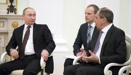 Russian President Vladimir Putin (L) listens to Foreign Minister Sergei Lavrov during a meeting with Austrian President Heinz Fischer at the Kremlin in Moscow, Russia, April 6, 2016. REUTERS/Alexander Zemlianichenko/Pool