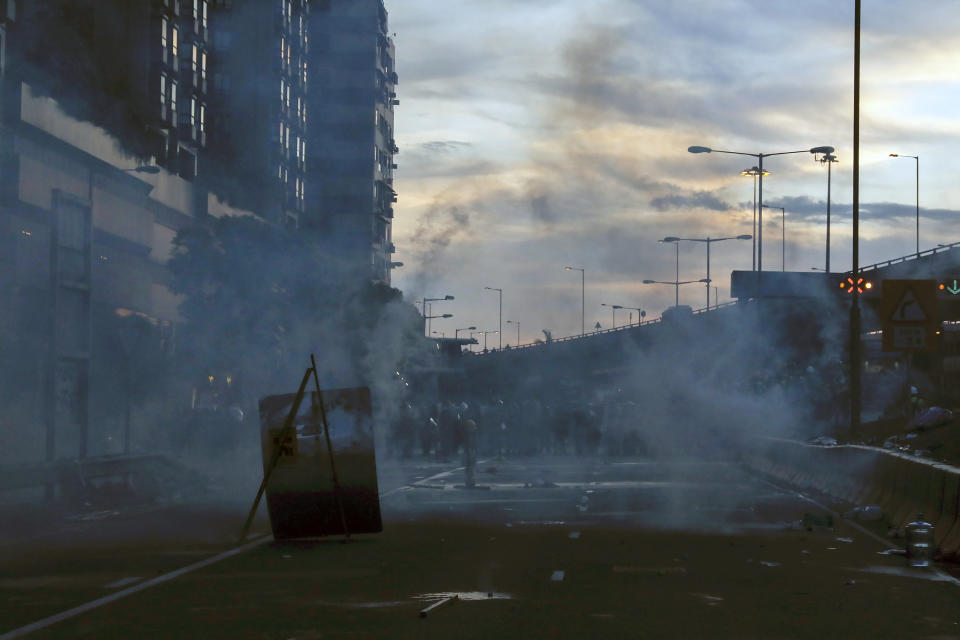 Smoke from tear gas is seen as riot policemen clear the protesters on a streets in Hong Kong, Sunday, July 28, 2019. Police launched tear gas at protesters in Hong Kong on Sunday for the second night in a row in another escalation of weeks-long anti-government and pro-democracy protests in the semi-autonomous Chinese territory. (AP Photo/Vincent Yu)