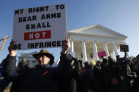 FILE - This Monday an. 20, 2020 file photo shows Billy Llewellyn, of Hanover Va., as he holds a sign in front of the Virginia State Capitol in Richmond, Va. In a state once synonymous with the Old South, Democrats are using their newfound legislative control to refashion Virginia as the region's progressive leader on racial, social and economic issues. (AP Photo/Steve Helber)