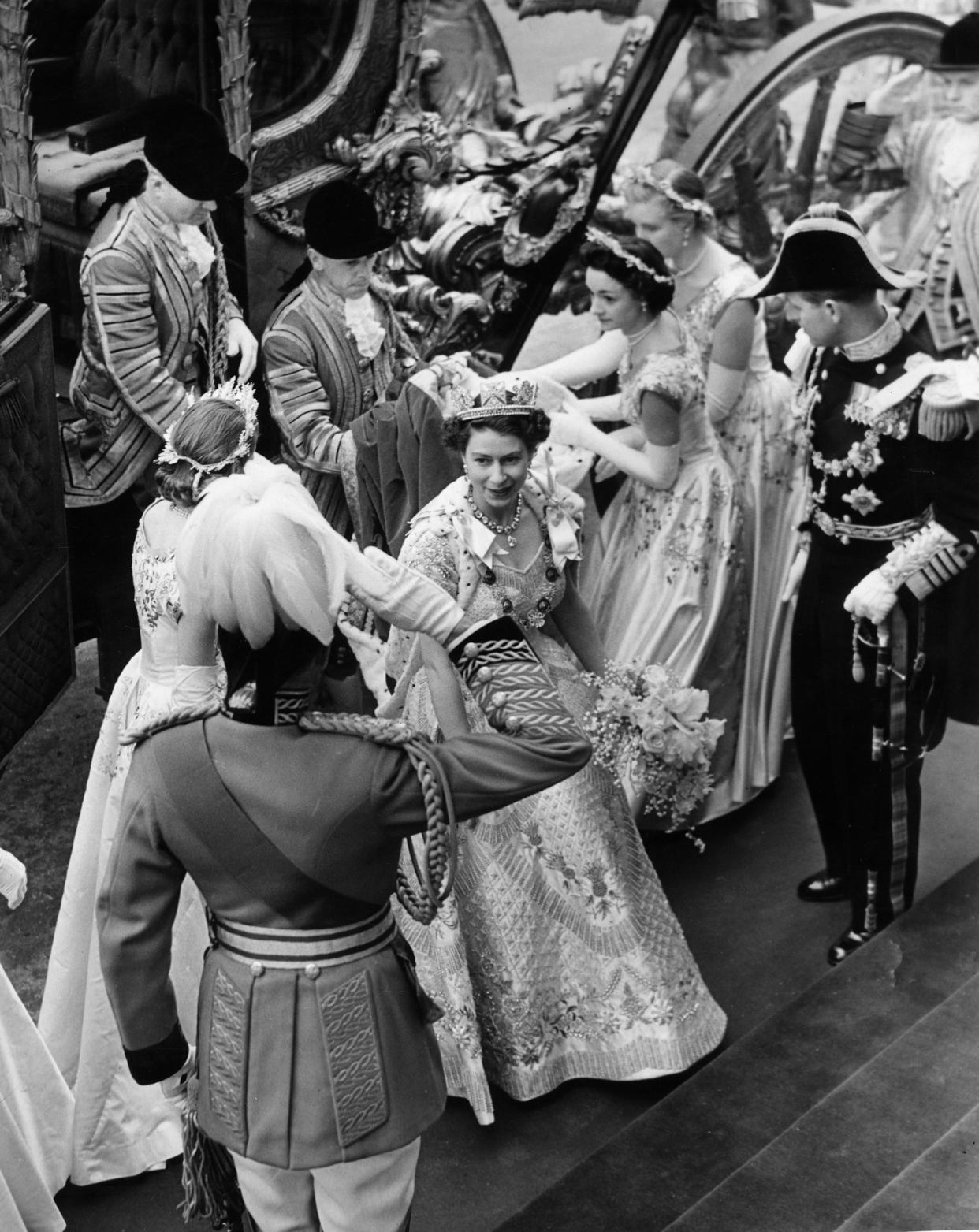 Queen Elizabeth II arrives at Westminster Abbey in the Coronation Coach in 1953.