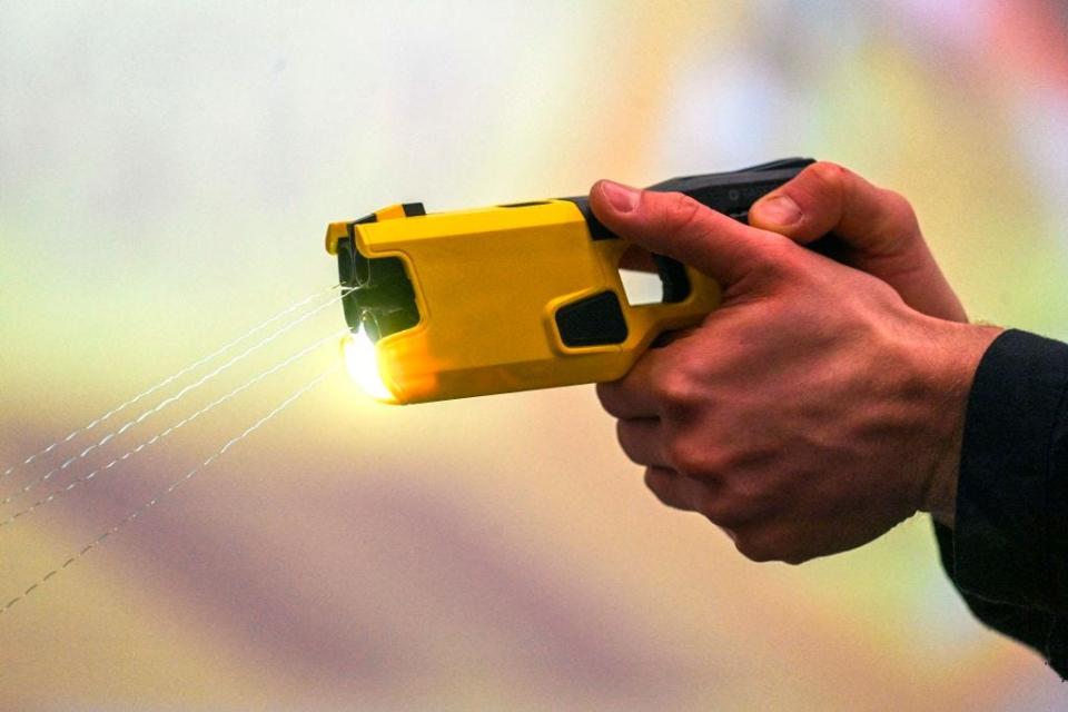 A police office holding a TASER 7 that they just fired.