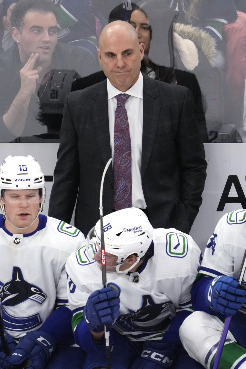 Vancouver Canucks head coach Rick Tocchet, top, watches his team during the third period of an NHL hockey game against the Chicago Blackhawks in Chicago, Sunday, March 26, 2023. (AP Photo/Nam Y. Huh)