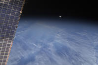 A full moon is visible with part of the International Space Station's solar array wing in this view above Earth's horizon, photographed by a crew member from the International Space Station while Space Shuttle Discovery (STS-128) remains docked with the station in this NASA handout photo taken September 3, 2009. REUTERS/NASA/Handout (UNITED STATES SCI TECH IMAGES OF THE DAY) FOR EDITORIAL USE ONLY. NOT FOR SALE FOR MARKETING OR ADVERTISING CAMPAIGNS