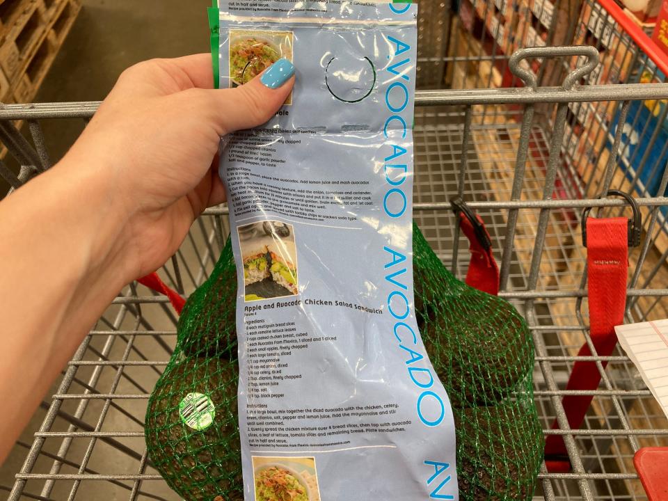 hand holding bag of avocados from costco