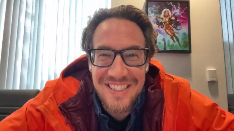 Ben Brode, in a bright orange waterproof coat.