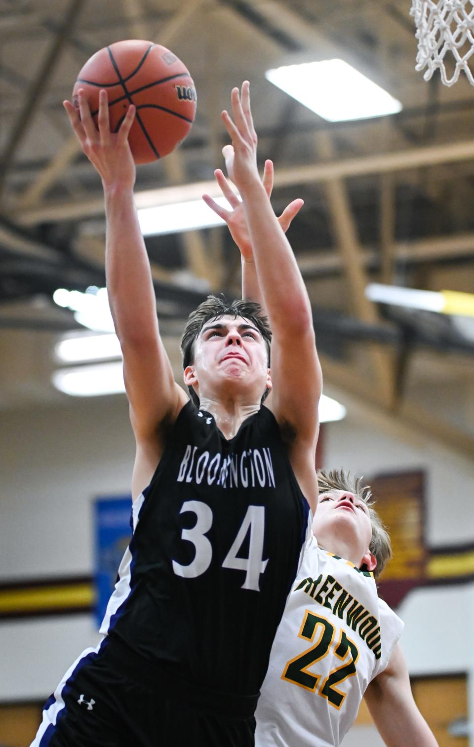 Bloomington South’s Vincent Moutardier (34) scores past Greenwood’s Joseph Ortman (22) during their IHSAA boys’ basketball sectional first round game at Bloomington North on Tuesday, Feb. 27, 2024.