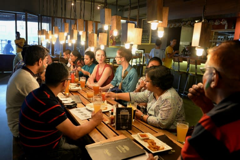 Customers share a conversation over beer at The Arbour Microbrewery in Bangalore