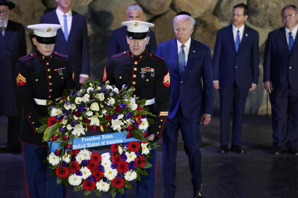 President Joe Biden, wearing a skullcap, participates in a wreath laying ceremony in the Hall of Remembrance at Yad Vashem, Wednesday, July 13, 2022, in Jerusalem. (AP Photo/Evan Vucci)