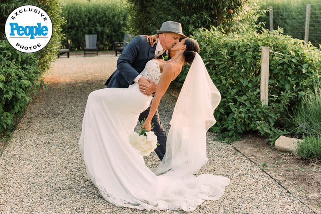 <p>Lola Grace Photography</p> Gino Palazzolo and Jasmine Pineda kiss on their wedding day