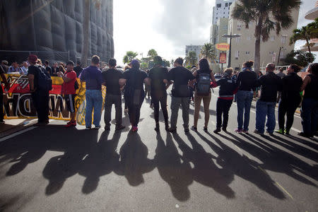 People protesting against first seminar of the Puerto Rico Oversight, Management and Economic Stability Act (PROMESA), form a line as they try to prevent participants from entering the hotel which is scheduled to be venue of the seminar, in San Juan, August 31, 2016. REUTERS/Ana Martinez