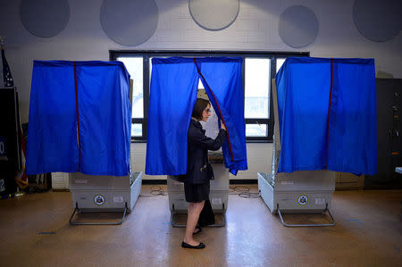 A voter leaves the booth after casting her ballot in the Pennsylvania primary at a polling place in Philadelphia, Pennsylvania, U.S., April 26, 2016. REUTERS/Charles Mostoller