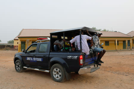 Independent National Electoral Commission (INEC) workers leave the Gwadabawa polling station, after the postponement of the presidential election in Yola, in Adamawa State, Nigeria February 16, 2019. REUTERS/Nyancho NwaNri