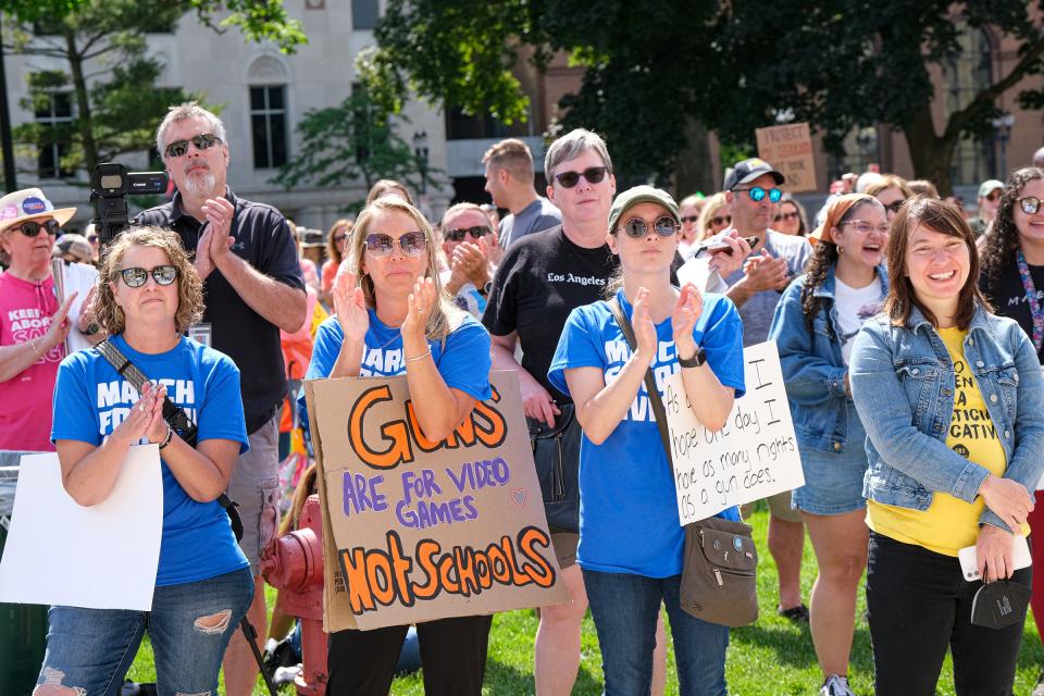 People attending the March for Our Lives rally in Lansing applaud a speaker Saturday, June 11, 2022.