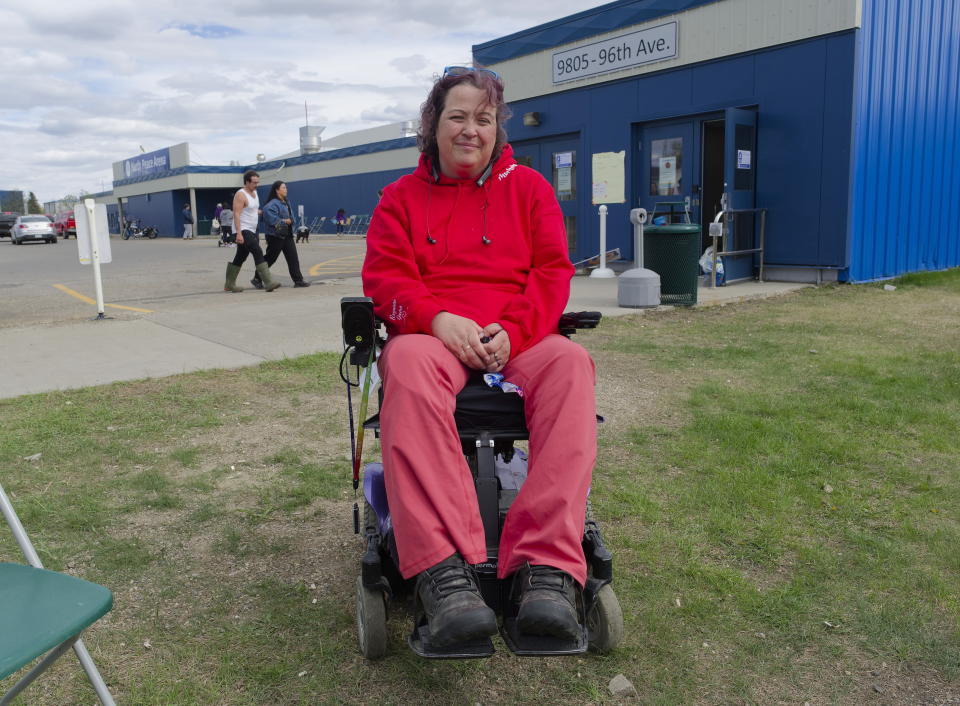 Kristen Leer, a Fort Nelson, B.C. evacuee, stops for a photo at the North Peace Arena in Fort St. John, B.C., on Monday, May 13, 2024. Leer said as a quadriplegic she is impressed with how the province is treating people with disabilities.Wildfires are forcing more people to evacuate their homes in dry and windy northeastern B.C. (Jesse Boily /The Canadian Press via AP)
