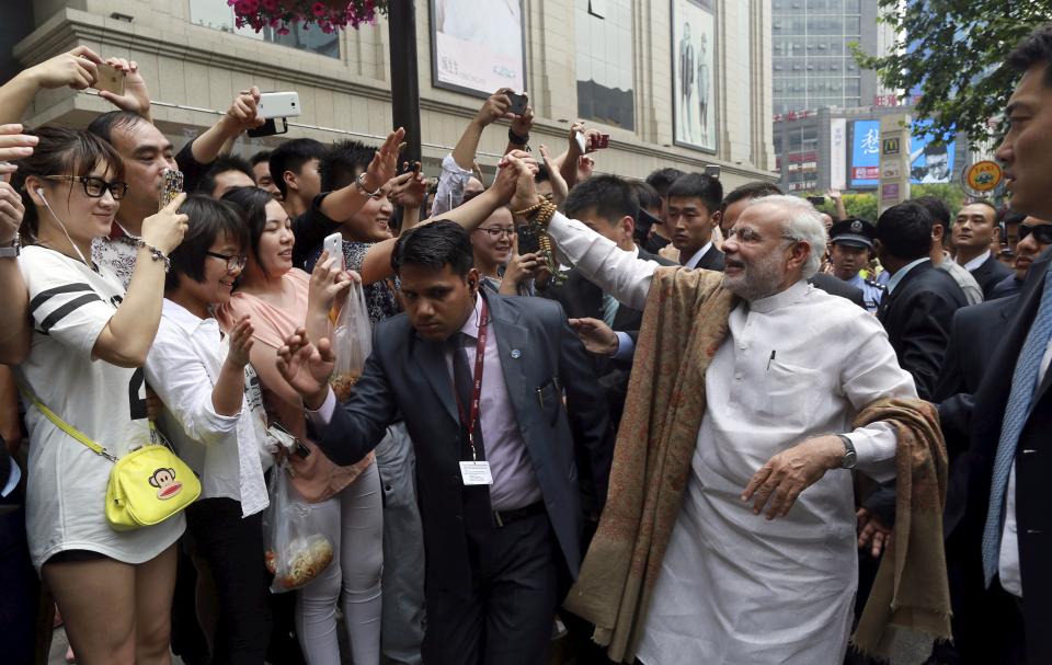 Indian Prime Minister Modi shakes hands with Chinese residents as he visits Xian