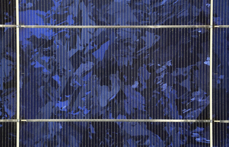 The surface of a solar panel is pictured in Feldheim near Treuenbrietzen, Germany, Wednesday, Sept. 28, 2022. Located about an hour and a half south of Berlin, the village of Feldheim has been energy self-sufficient for more than a decade. (AP Photo/Michael Sohn)