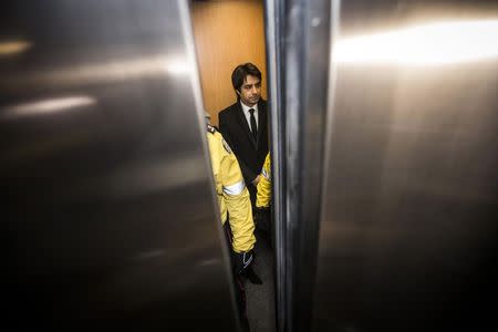 Jian Ghomeshi, a former celebrity radio host who has been charged with multiple counts of sexual assault, arrives at court as elevator doors close in Toronto January 8, 2015. REUTERS/Mark Blinch