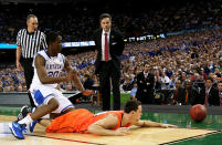 NEW ORLEANS, LA - MARCH 31: Kyle Kuric #14 of the Louisville Cardinals goes after a loose ball in front of Doron Lamb #20 of the Kentucky Wildcats as head coach Rick Pitino of the Cardinals looks on in the second half during the National Semifinal game of the 2012 NCAA Division I Men's Basketball Championship at the Mercedes-Benz Superdome on March 31, 2012 in New Orleans, Louisiana. (Photo by Chris Graythen/Getty Images)